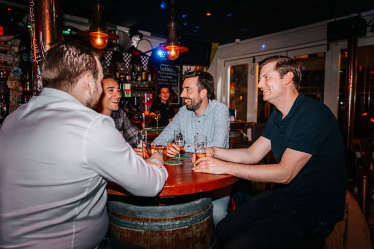 Young men drinking beer at a bar in Zandvoort